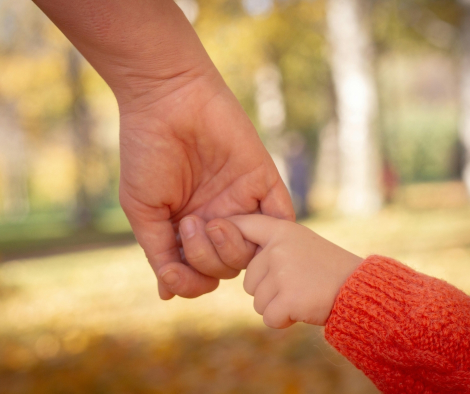 parent holding child's hand